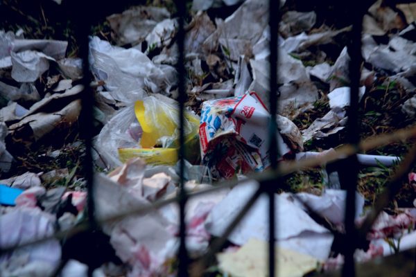 A close-up view of plastic waste scattered on the ground in Bangladesh.